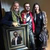 Ringo Starr standing next to portrait by Fabian Perez and Lucy Perez