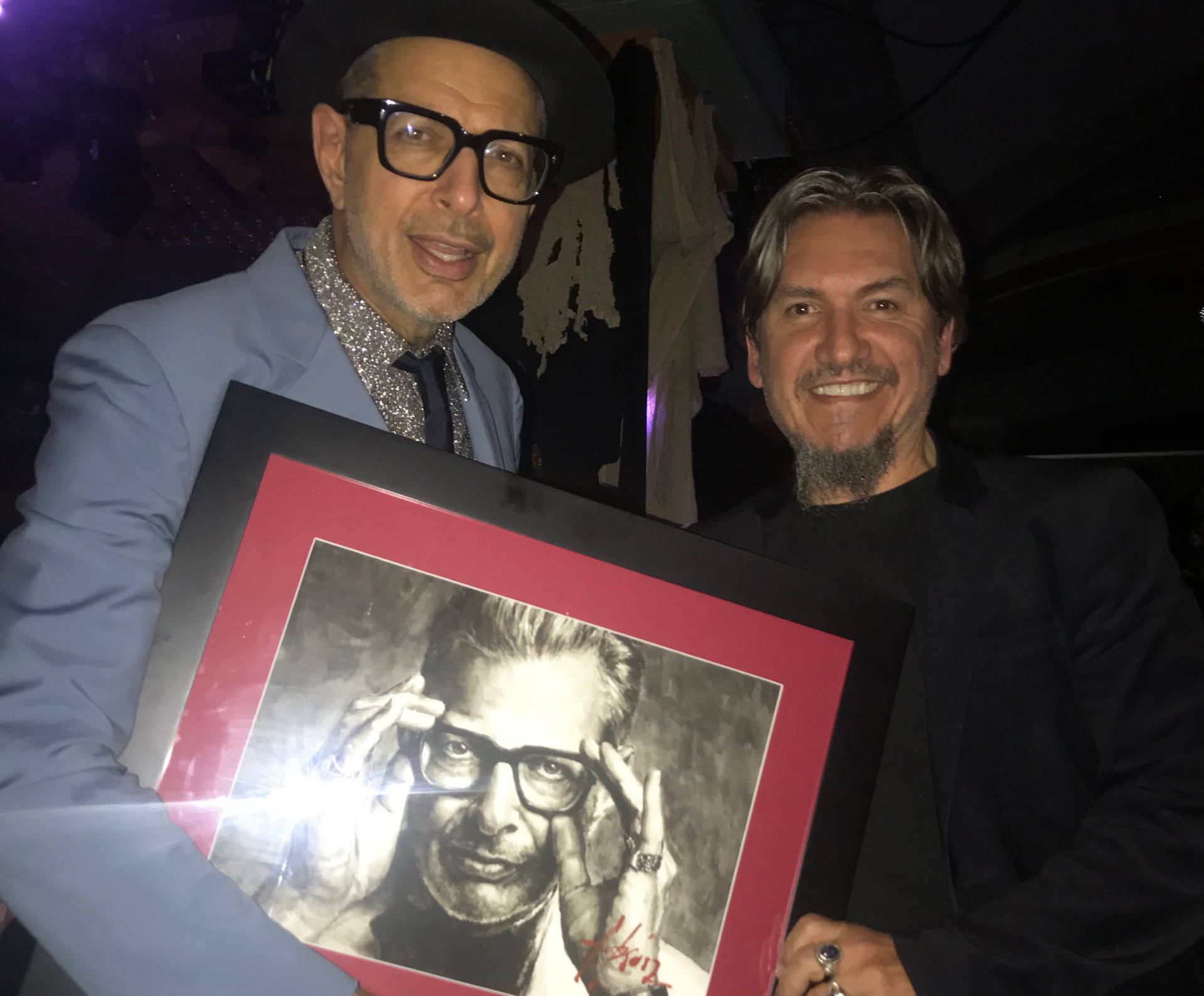 Jeff Goldblum holding portrait next to Fabian Perez