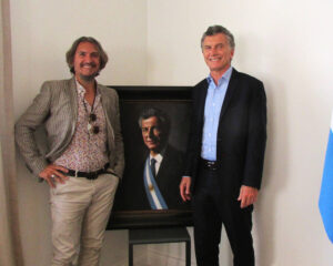 Mauricio Macri standing next to portrait by Fabian Perez