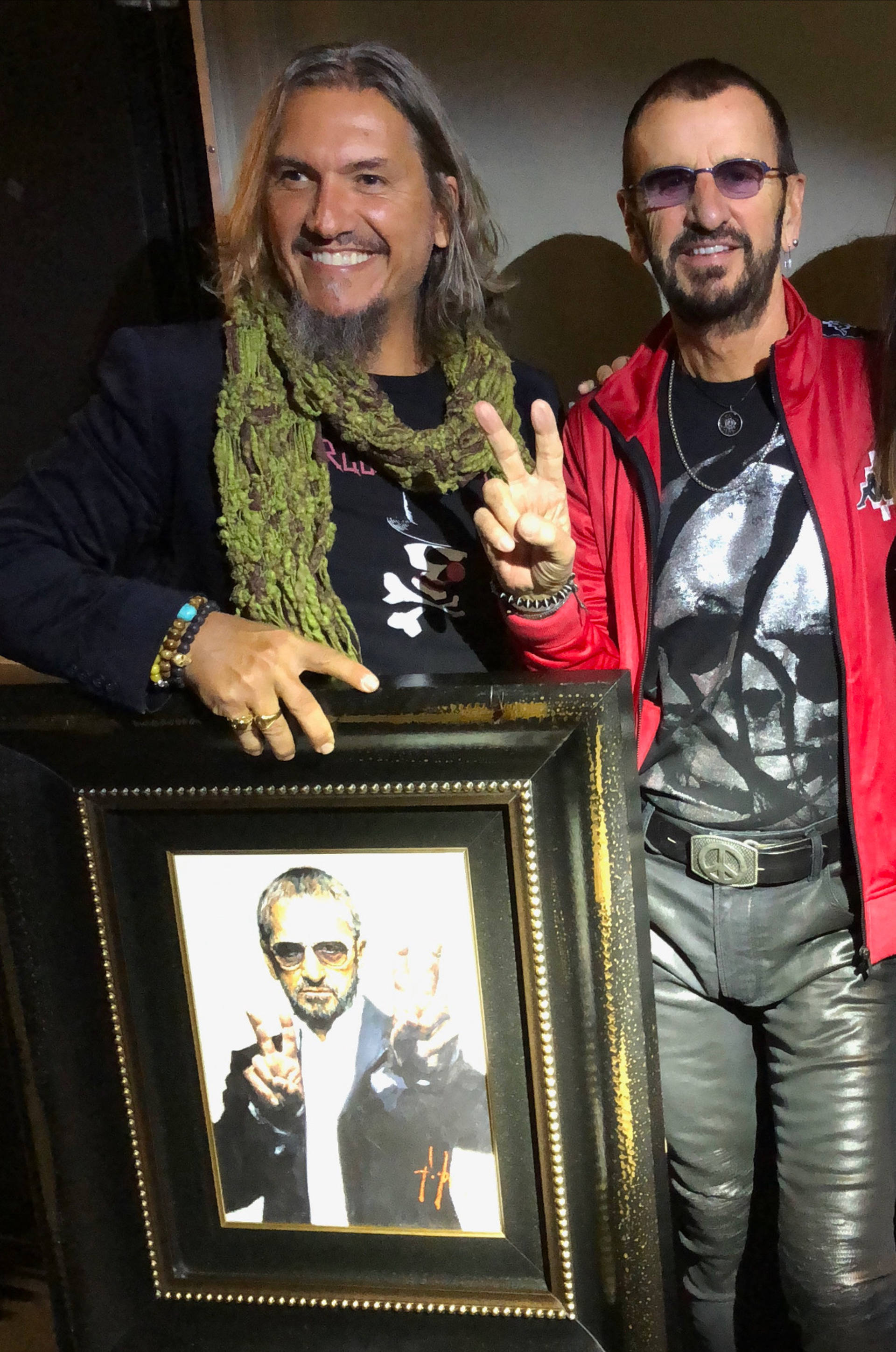 Ringo Starr standing next to portrait by Fabian Perez