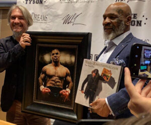 Mike Tyson standing next to portrait by Fabian Perez
